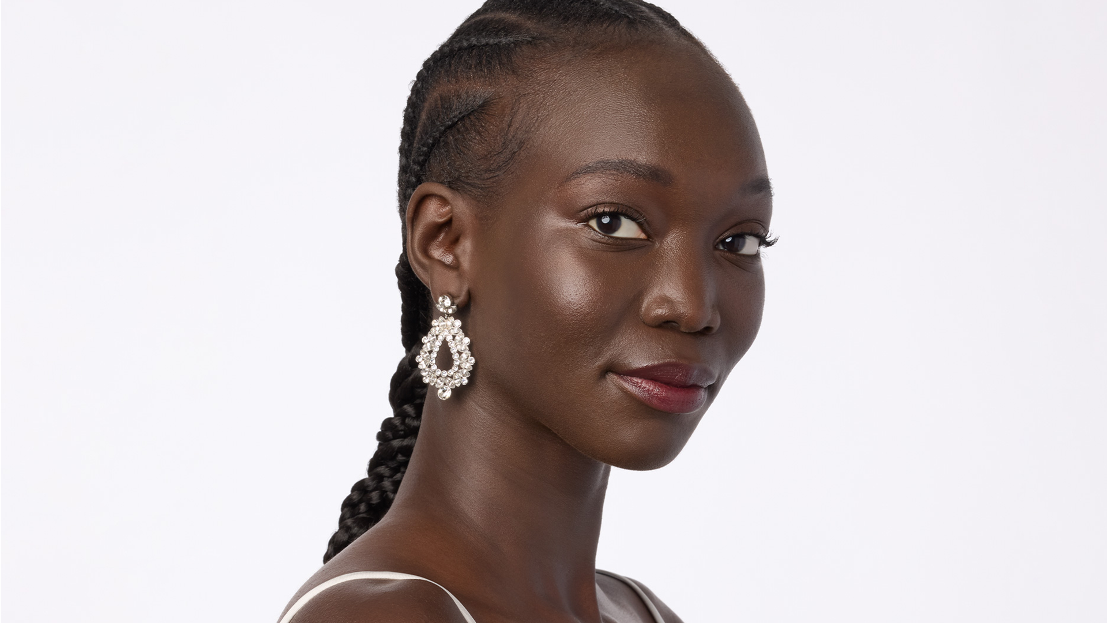 A woman wearing sparkly earrings. 